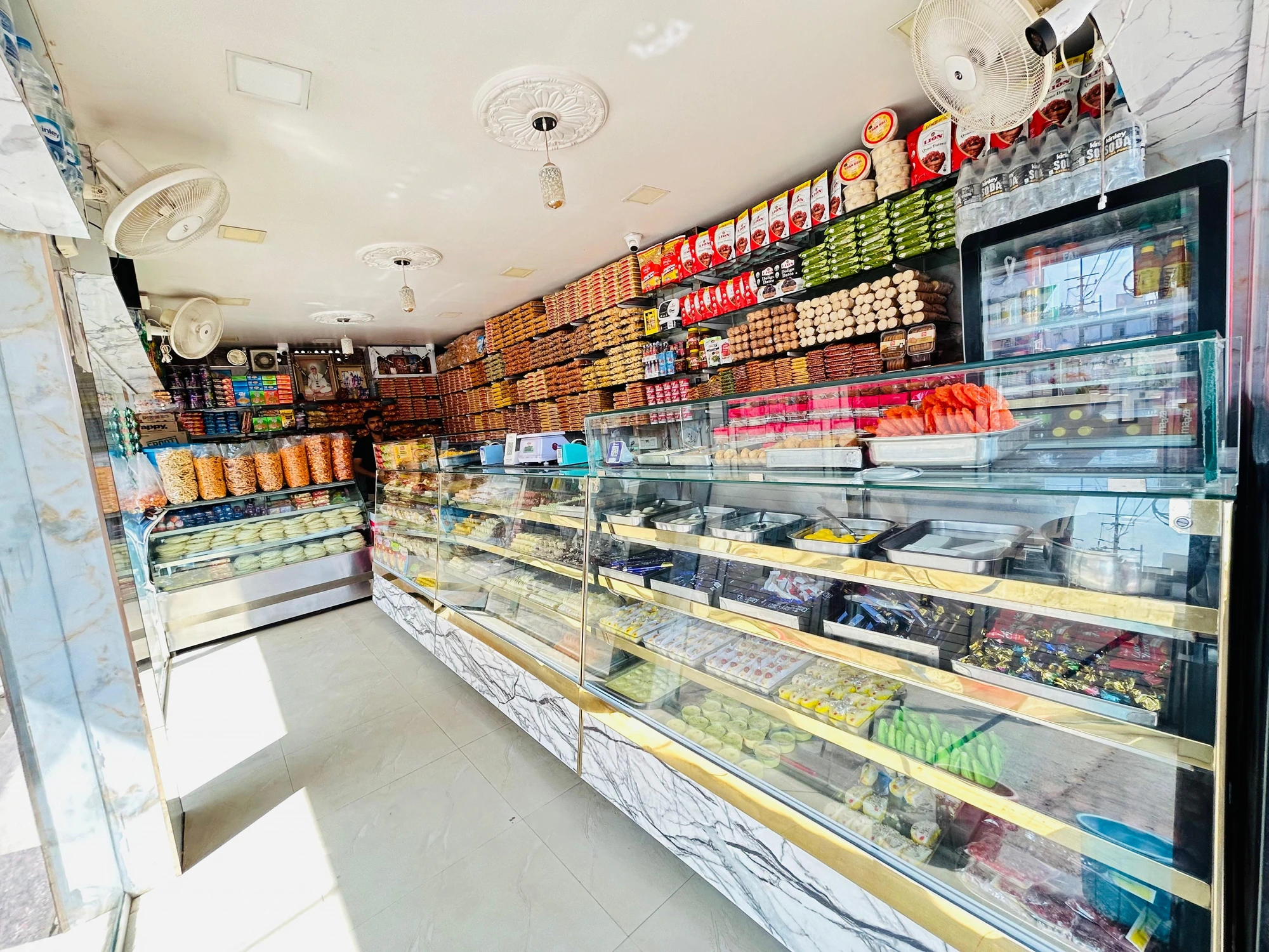 Inside Ranisa Kamdhenu Sweets — display counter